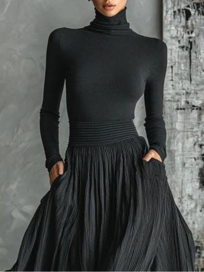 Conjunto negro real con top de cuello alto y manga larga, falda plisada con frunce