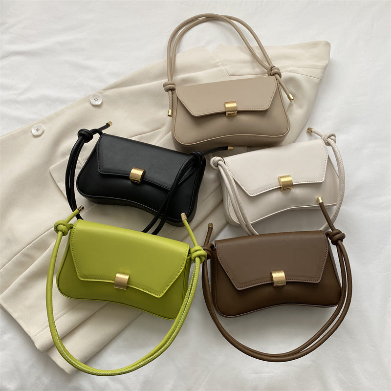 Conjunto de bolsos mini: negro, crema, marrón y verde lima, con hebilla dorada.