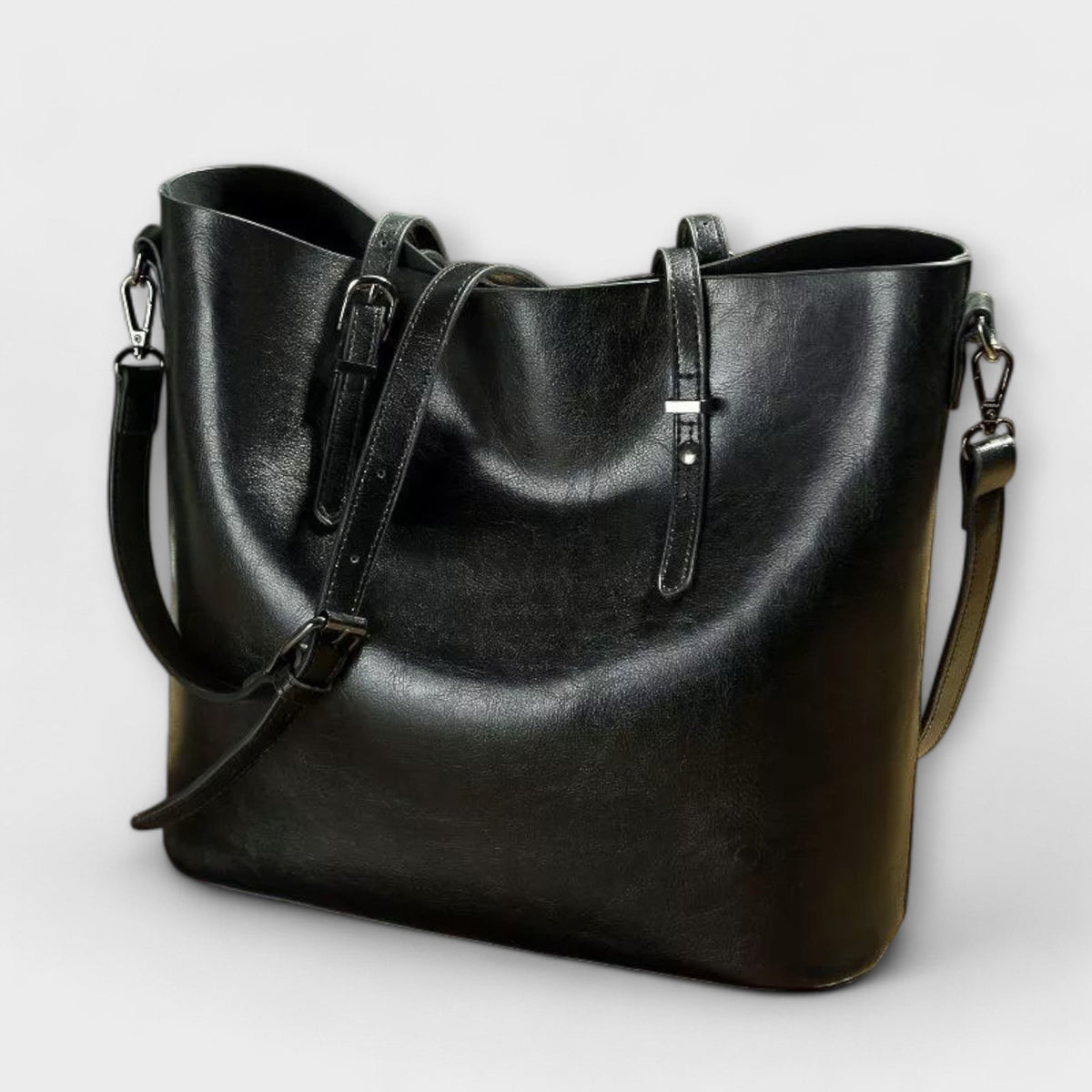 Bolso Tavrèa negro de piel con bandolera y doble asa frontal