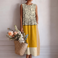 Vestido midi sin mangas bicolor con lunares negros y franjas amarillas y crema