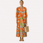 Vestido midi naranja con flores y hojas, cuello V, mangas 3/4 y dobladillo recto