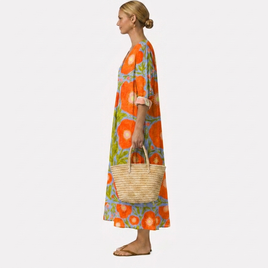 Vestido midi estampado floral naranja y verde con manga 3/4, falda amplia y bolso de rafia