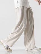Pantalón wide leg de lino y algodón beige claro, dobladillo amplio y tela con textura.