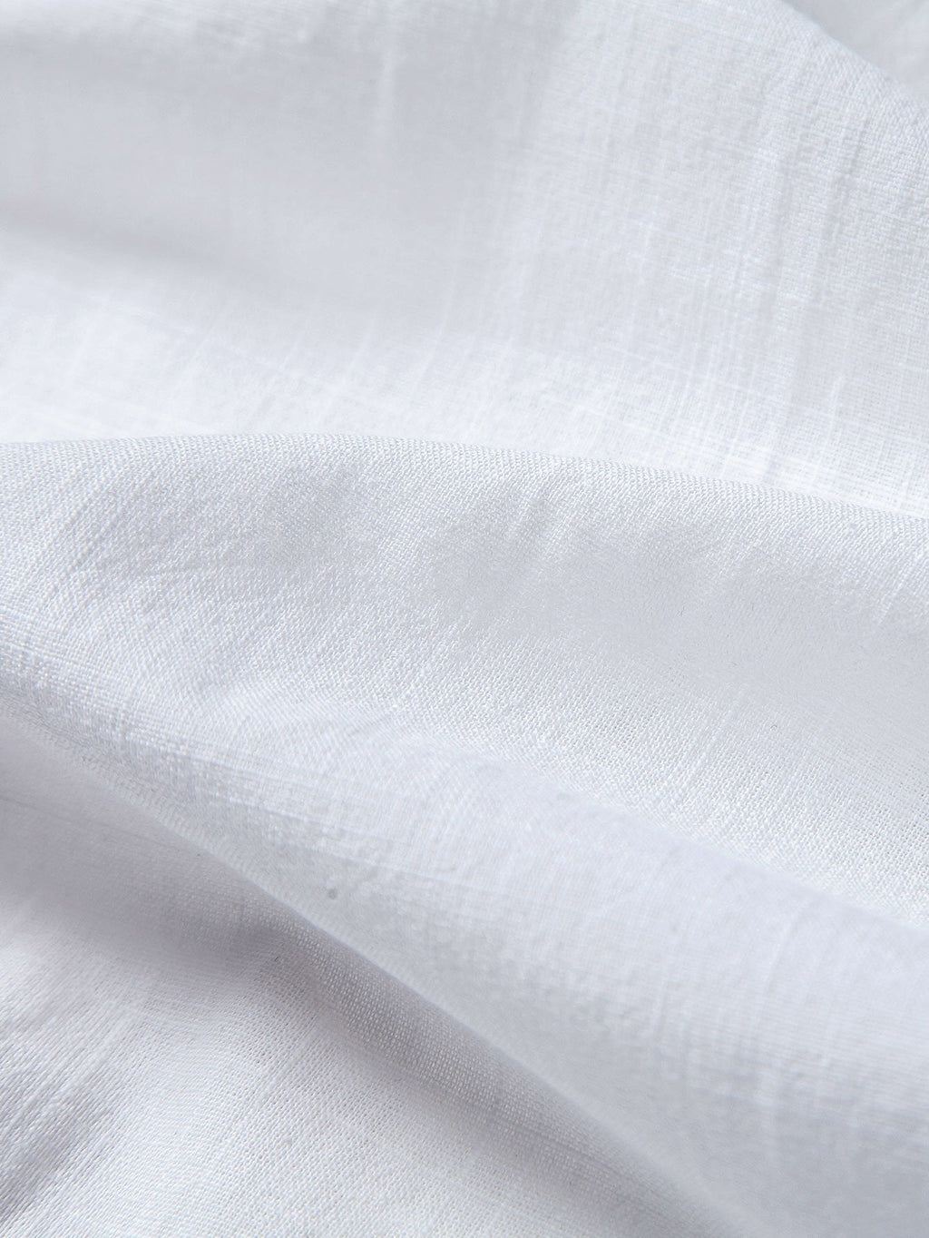 Tela blanca tipo lino de algodón, con textura sutil
