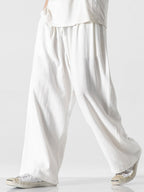 Pantalón wide leg de lino y algodón blanco roto, caída suelta y frunces en la cintura.