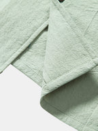 Camisa de algodón texturizado con dobladillo y botones, verde claro