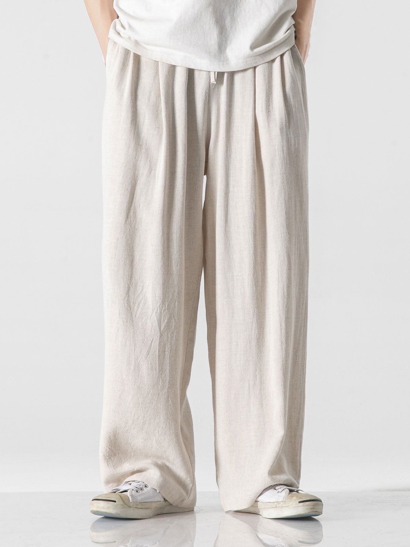 Pantalón wide leg de lino y algodón blanco roto, cintura elástica y pierna ancha.