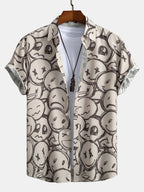 Camisa de manga corta color arena con estampado de caritas y cuello con botones