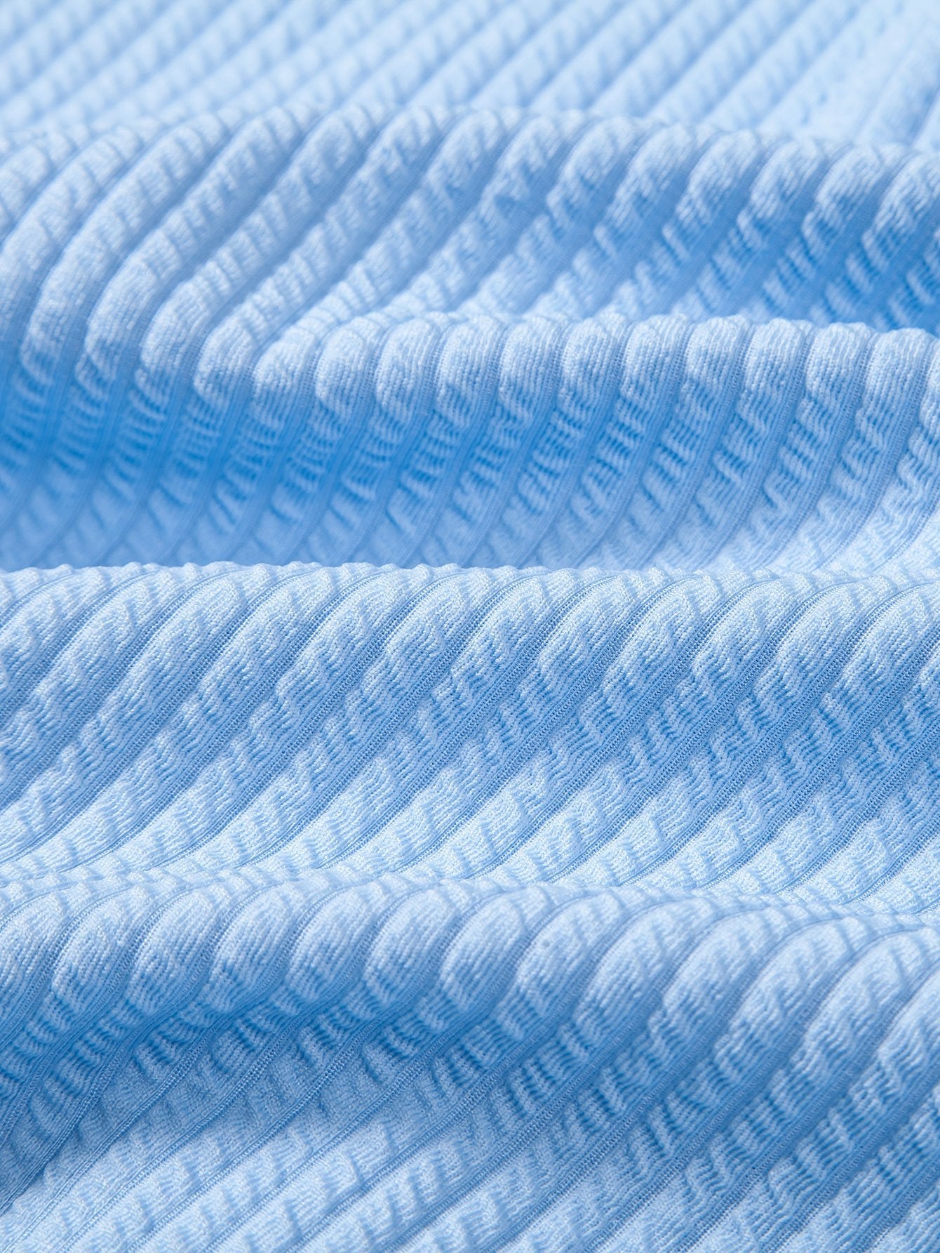Textura de tejido acanalado celeste, detalle de la camisa
