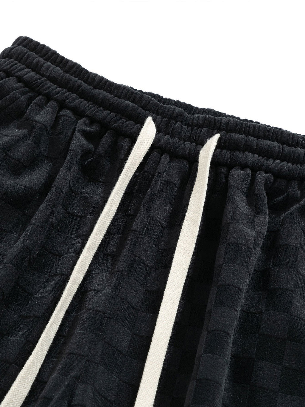 Cintura elástica con cordones blancos y patrón texturizado del pantalón