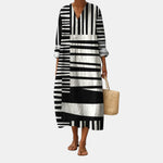 Vestido midi blanco y negro con rayas gráficas, escote V y mangas 3/4