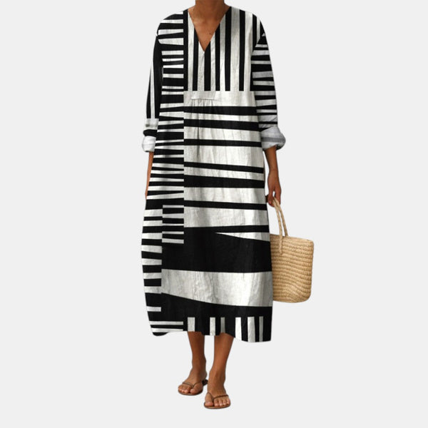 Vestido midi blanco y negro con rayas gráficas, escote V y mangas 3/4