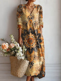 Vestido largo bohemio multicolor con estampado floral dorado y negro, manga larga y escote en V